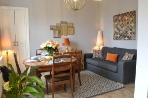 a living room with a table and a couch at Stunning Period Townhouse with Garden, Walking Distance to Town in Dumfries
