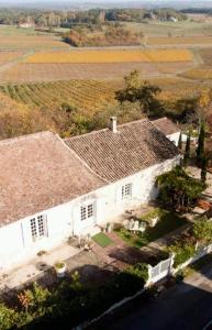 an aerial view of a white house with a roof at Cœur de vigne à Colombier 24560 in Issigeac