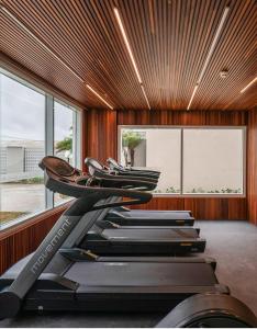 a row of treadmills in a room with windows at Apartamento Vista Mar Salinas Premium Resort in Salinópolis