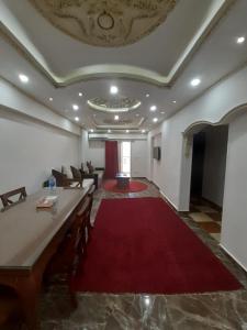a large living room with a red carpet and a couch at Saraya Eltram-families only in Alexandria