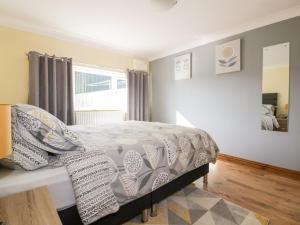 a bedroom with a bed and a window at Lower Brambleside in Truro