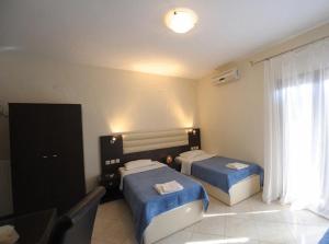A bed or beds in a room at Panorama Spa Hotel