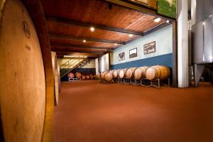 a room with a bunch of wine barrels in it at Tenuta San Vito In Fior Di Selva in Montelupo Fiorentino