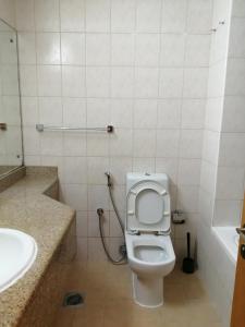 a bathroom with a toilet and a sink at Furnished Studio in Dubai