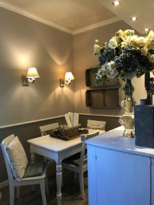 a dining room with a table and a vase of flowers at Il Pioppo Antico in Viggiù +84 photos