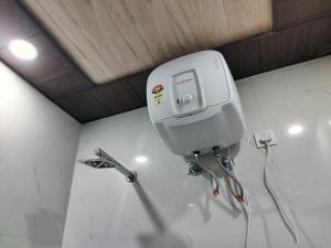 a water dispenser on the wall of a room at Hotel Orange Classic in Rishīkesh