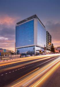 a large glass building with a highway in front of it at Blue inn Boutique in Abha
