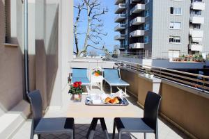 a table on a balcony with a tray of food at Hotel Fedora Rimini in Rimini