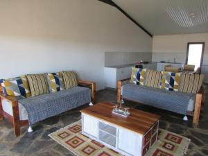 a living room with two couches and a coffee table at Rogge Cloof in Sutherland
