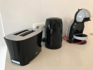 two toasters sitting on a counter next to a toaster at Whaaw Oostende in Ostend