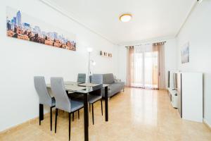 a dining room with a table and chairs at Apartamento COSTAMARINA in Cabo Roig