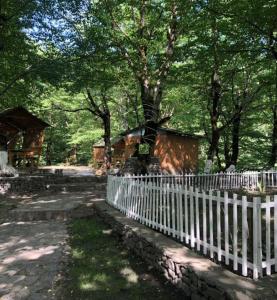 a white fence in front of a house and trees at Gabala Explorers' Villa near Tufandag in Gabala