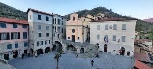 a group of buildings with stairs in a town at La Gallina Nel Castello in Albenga