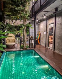 a swimming pool in the middle of a house at Exclusive access to the whole garden. in Bangkok