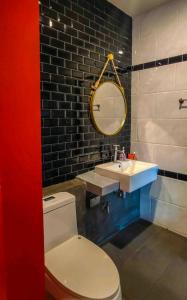 a bathroom with a toilet and a sink and a mirror at Exclusive access to the whole garden. in Bangkok