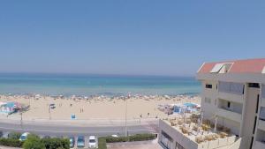 a beach with a lot of people and the ocean at Zibibbo Beach Apartments - Trapani in Trapani