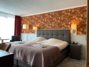 Postel nebo postele na pokoji v ubytování Hotel Cafe Restaurant Duinzicht