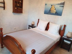 a bedroom with a wooden bed with two night stands at Paradise in Peille
