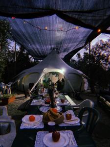 a table in a tent with food on it at אוהל הזית in Maʼor
