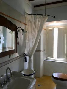 a bathroom with a sink and a toilet and a window at Barga Lucca Centro Storico Con giardino in Barga