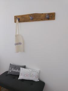 a shelf above a bed with a pillow and a bag at Ferienwohnung Langgöns in Langgöns