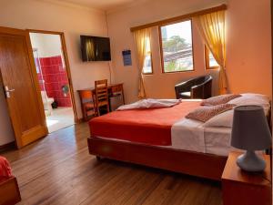 a bedroom with a bed and a window and a bathroom at Hotel Luz de Luna Barrio Escalante in San José