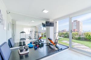 a room with a gym with a large window at Hotel Romimar 3* Sup in Punta del Este