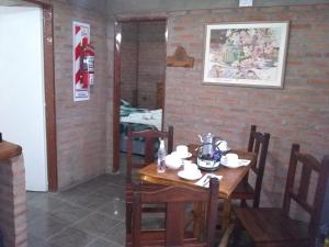 a dining room with a wooden table and chairs at La Galensa in Trevelín