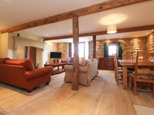 a living room with furniture and a stone wall at Usherwoods Barn in Lancaster