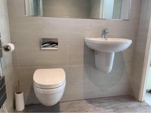 a bathroom with a toilet and a sink at 20 Strawberry Hill cosy cottage sleeps 5 in Hayle