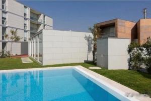 a swimming pool in front of a building at Sea, Surf and Sun in Azurara