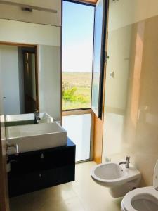łazienka z umywalką, wanną i toaletą w obiekcie Sea, Surf and Sun w mieście Azurara