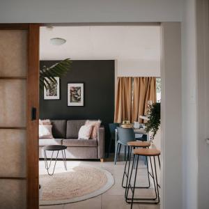 a living room with a couch and a table at Pakiri Beach Holiday Park in Pakiri