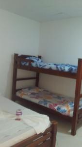 a room with two bunk beds and a bed at Hotel El Puerto in Tolú