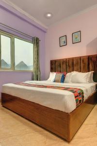 een slaapkamer met een groot bed met paarse muren bij Hotel Sethi Legacy in Haridwār