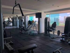 a gym with cardio equipment and a view of the city at Studio Business West Flat in Mossoró