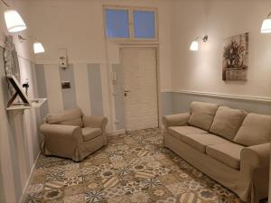 a living room with a couch and a chair at Il giardino segreto in Taranto