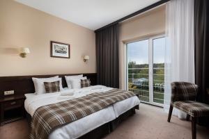 Posteľ alebo postele v izbe v ubytovaní The Amber Business & Spa Hotel