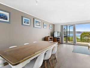 a dining room with a large table and chairs at Apartment 29 Pacific Apartments in Lorne