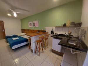 cocina con mesa y 1 cama en una habitación en Memorália Suítes, en Arraial do Cabo
