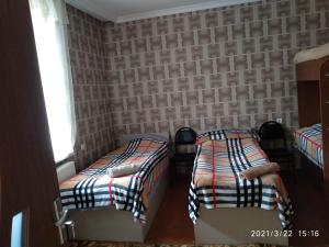 A bed or beds in a room at Qusha Guesthouse Meeting in the mountains and views