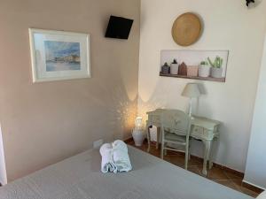 a bedroom with a bed and a table and a chair at B&B Casavecchia in Gallipoli