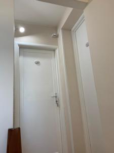 a white door in a room with a wall at B&B Casavecchia in Gallipoli