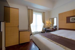 Postel nebo postele na pokoji v ubytování Hotel Monterey Ginza