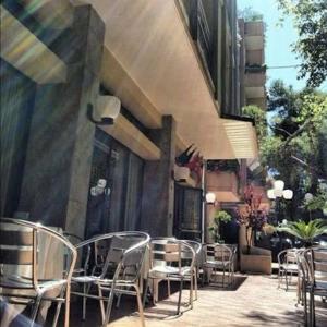 a group of chairs sitting outside of a building at HOTEL LABRADOR in Cattolica