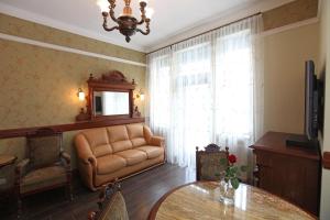 a living room with a couch and a table at Apartamenty Klejnot Sopotu in Sopot