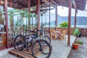 two bikes parked outside of a restaurant with a view of the water at The Joglo Beratan in Bedugul