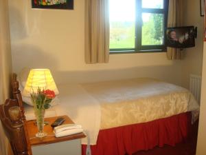 A bed or beds in a room at Athlumney Manor Guest Accommodation