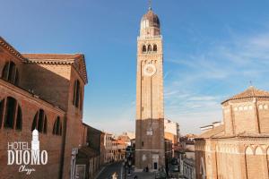a clock tower in the middle of a city at Duomo Boutique Hotel in Chioggia