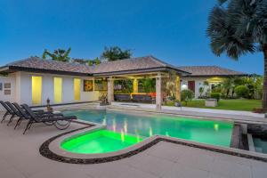 a home with a swimming pool and a house at Orchid Paradise Homes Villa in Hua Hin